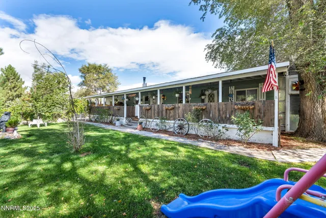 a view of a house with backyard sitting area and garden