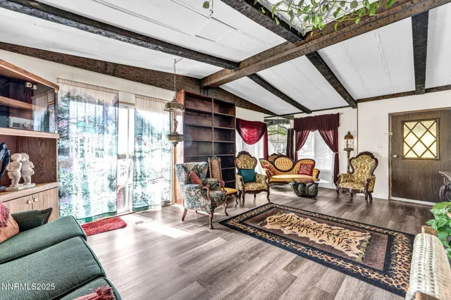 a living room with furniture and a floor to ceiling window