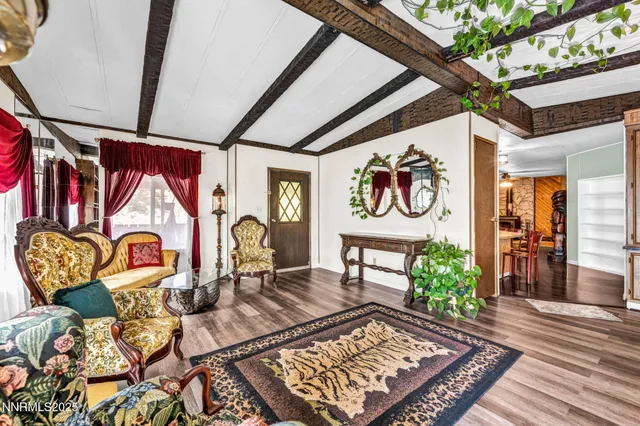 a kitchen with stainless steel appliances granite countertop a table chairs refrigerator and sink