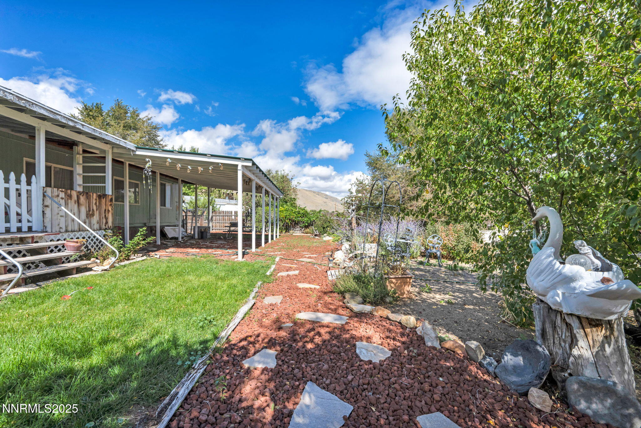 4000 Bobolink Circle Reno, NV 89508 - Photo 42 of 66 a view of a backyard with table and chairs with wooden fence