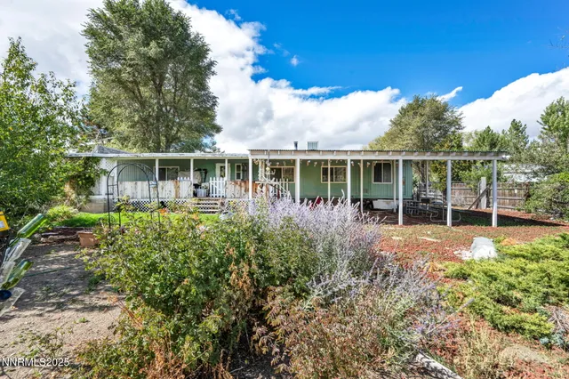 a view of a house with a yard and a patio