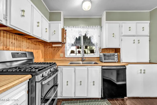 a kitchen with granite countertop a stove and a sink