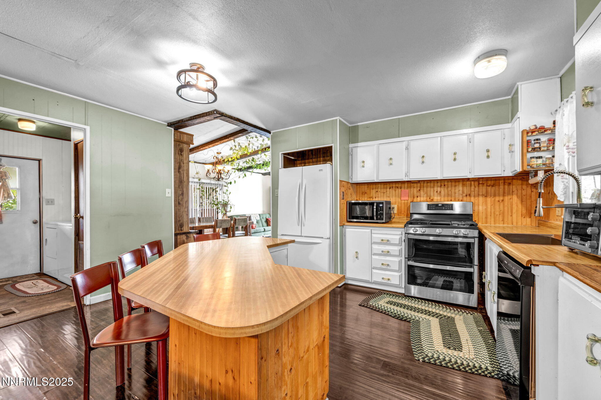 4000 Bobolink Circle Reno, NV 89508 - Photo 7 of 66 a kitchen with stainless steel appliances granite countertop a stove oven and a refrigerator with white cabinets
