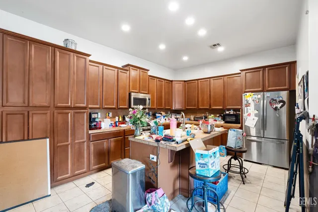 a room with stainless steel appliances a stove a sink dishwasher and a cabinets