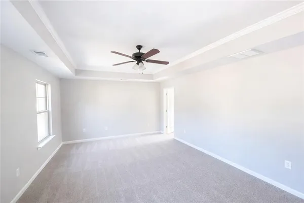 a view of room with window and ceiling fan