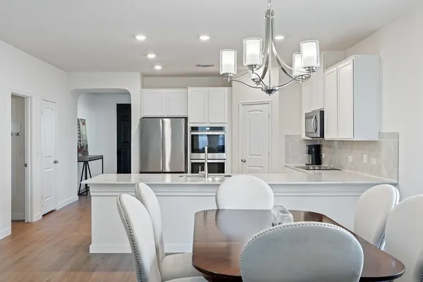 a large kitchen with a table and chairs