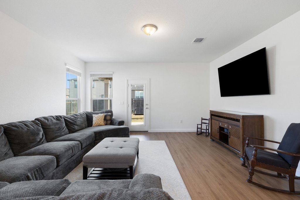 1926 Dragonfly Loop Bastrop, TX 78602 - Photo 12 of 32 a living room with furniture and a flat screen tv