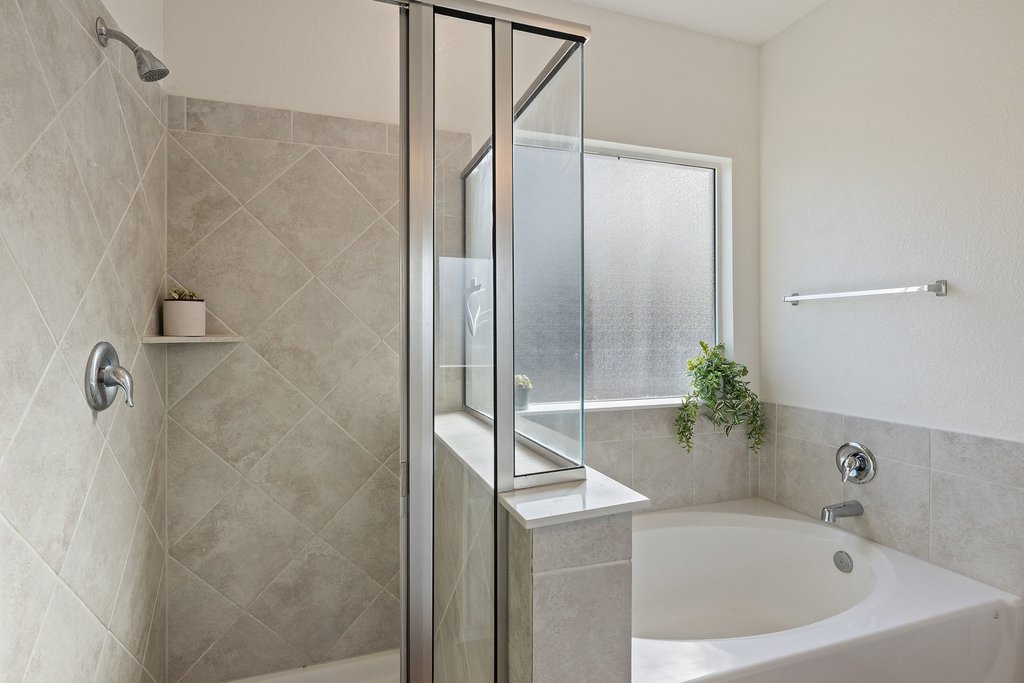 1926 Dragonfly Loop Bastrop, TX 78602 - Photo 15 of 33 a bathroom with a bathtub and shower