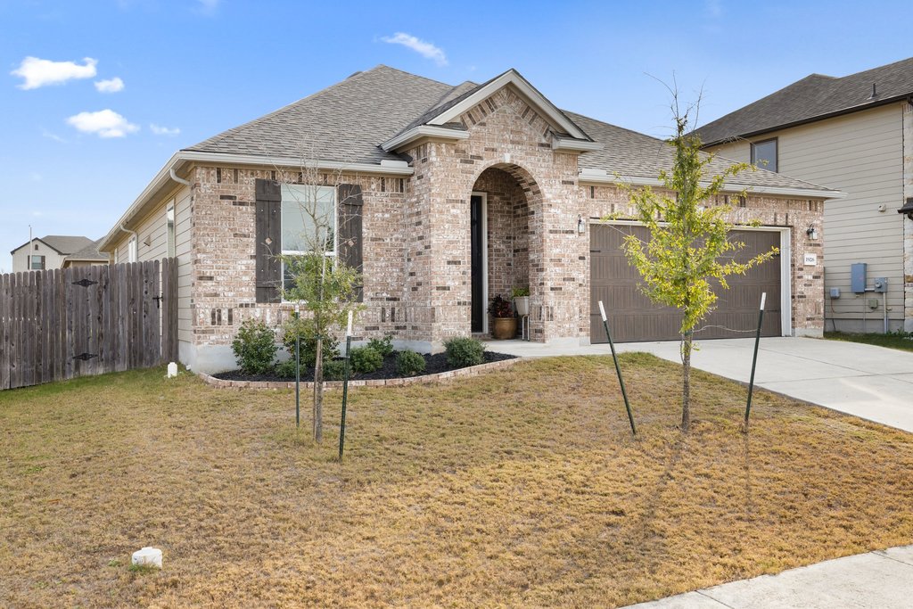 a front view of a house with garden