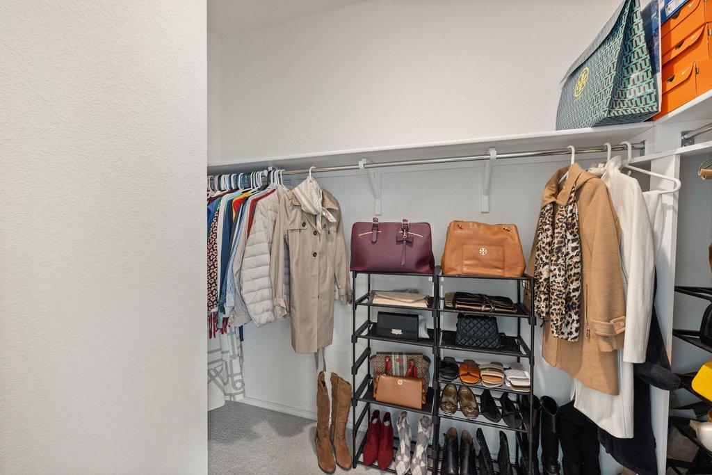 1926 Dragonfly Loop Bastrop, TX 78602 - Photo 20 of 32 a view of walk in closet with clothes and shoes