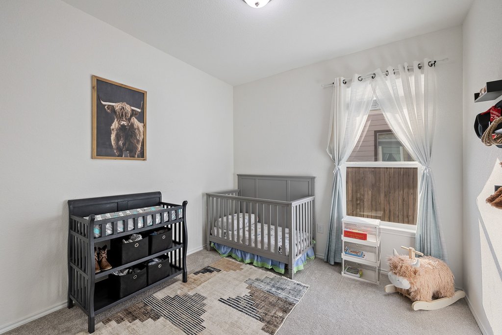 1926 Dragonfly Loop Bastrop, TX 78602 - Photo 22 of 32 a bedroom with a bed and a window
