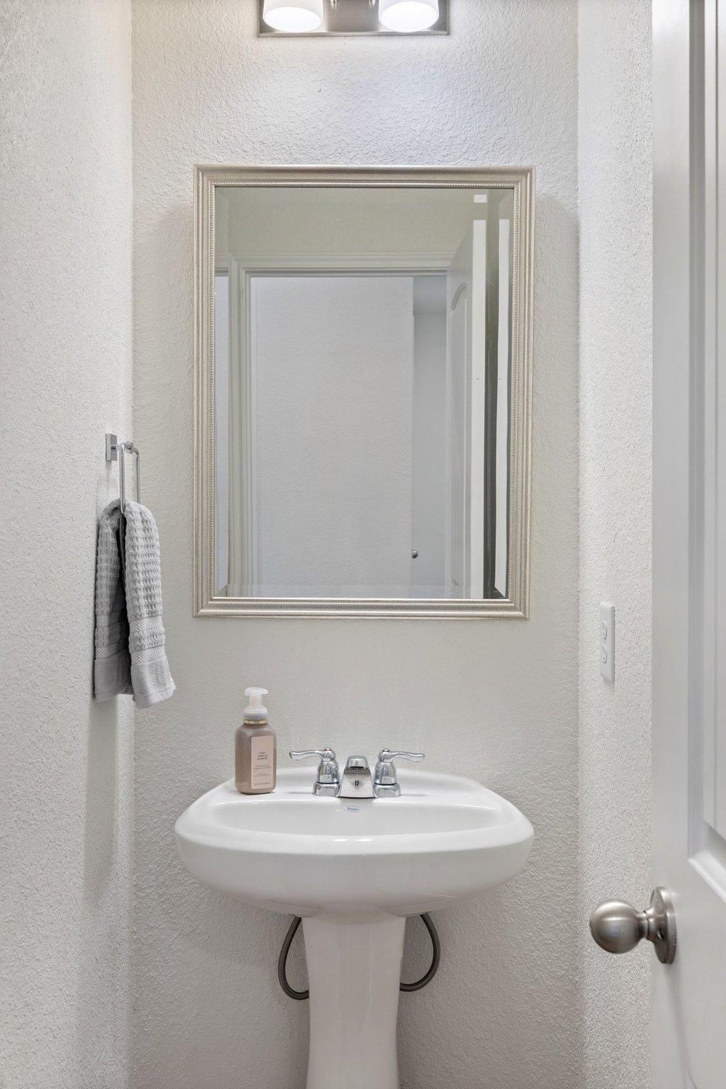 1926 Dragonfly Loop Bastrop, TX 78602 - Photo 24 of 33 a bathroom with a sink vanity and a mirror