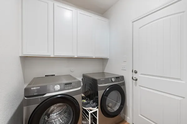 a bathroom with a sink a toilet and a large mirror