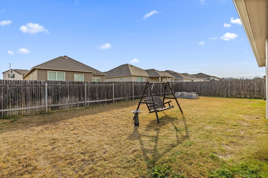 1926 Dragonfly Loop Bastrop, TX 78602 - Photo 30 of 32 a view of a house with a yard