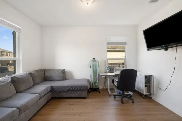 a living room with furniture and a wooden floor