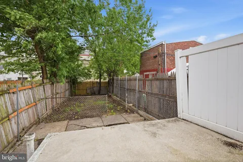 a view of backyard with deck and seating area
