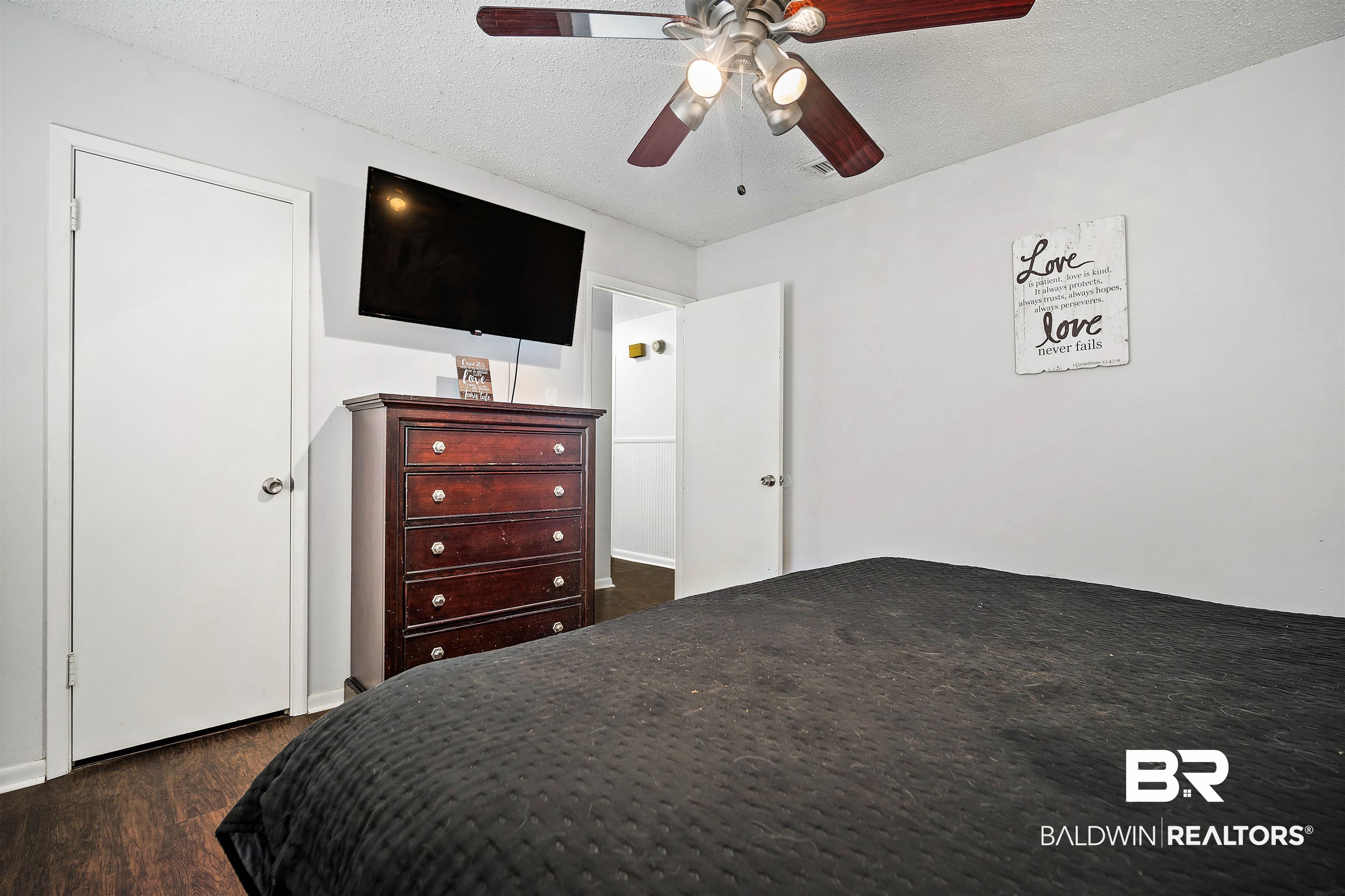 5110 Wilmer Road Wilmer, AL 36587 - Photo 16 of 24 Bedroom featuring a textured ceiling, dark hardwood / wood-style flooring, and ceiling fan