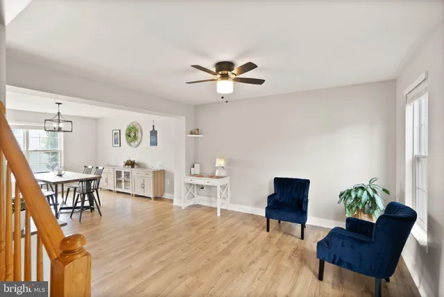 a dining room with wooden floor and a window