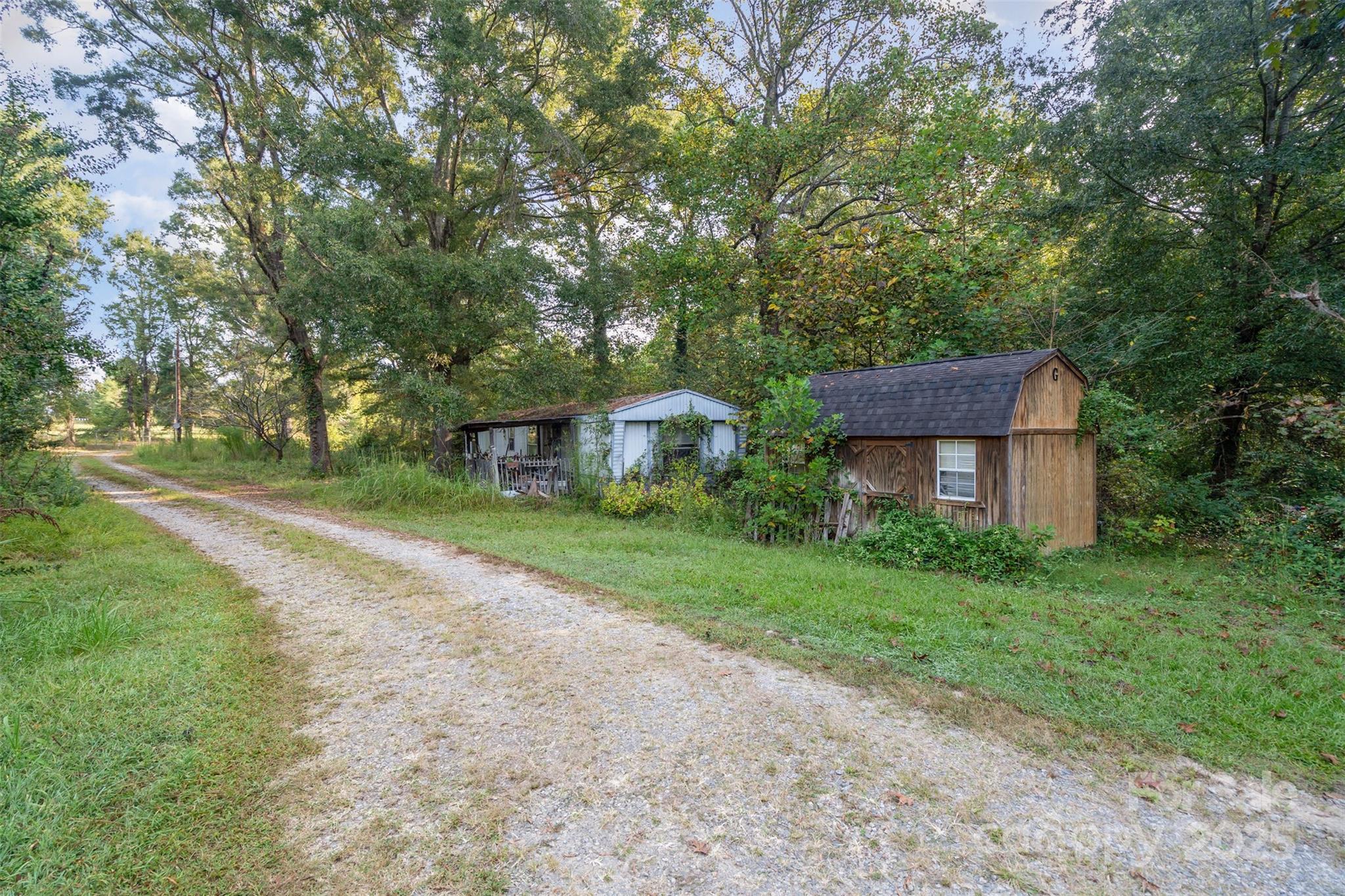 3164 Andrew Link Road Iron Station, NC 28080 - Photo 3 of 17 a view of a house with a yard and large trees