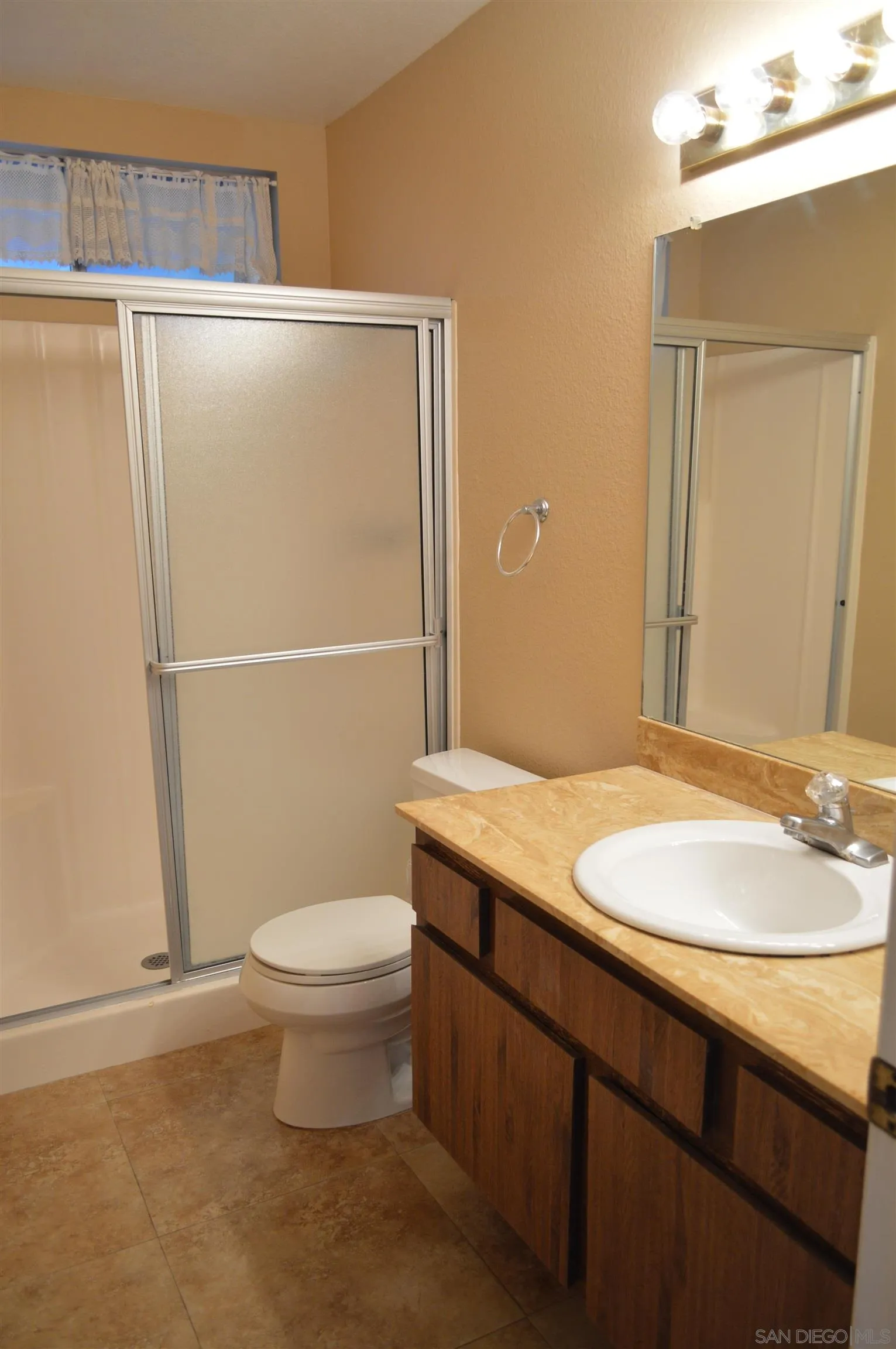 13353 Sutter Mill Road Poway, CA 92064 - Photo 11 of 14 a bathroom with a granite countertop sink toilet and shower