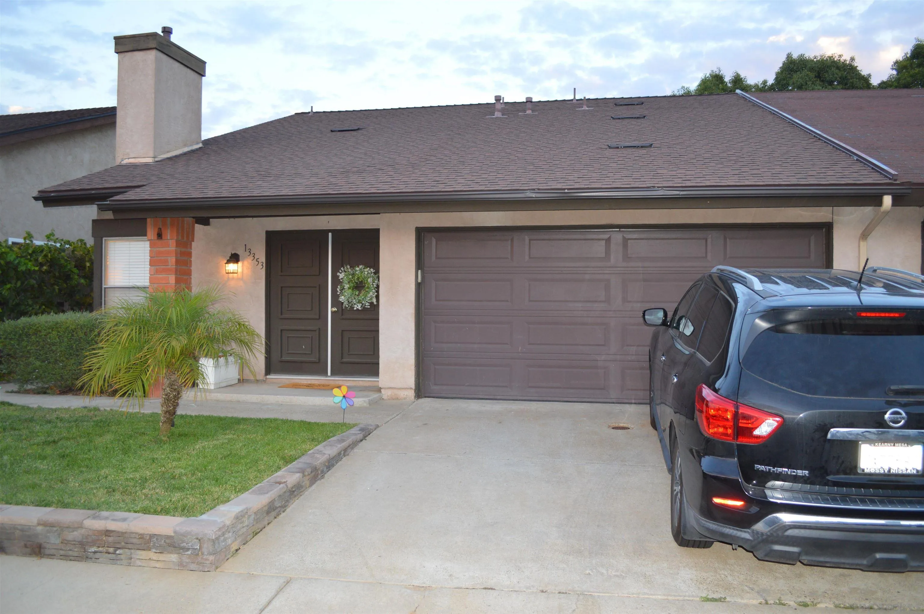 13353 Sutter Mill Road Poway, CA 92064 - Photo 2 of 14 a front view of a house with a yard and garage