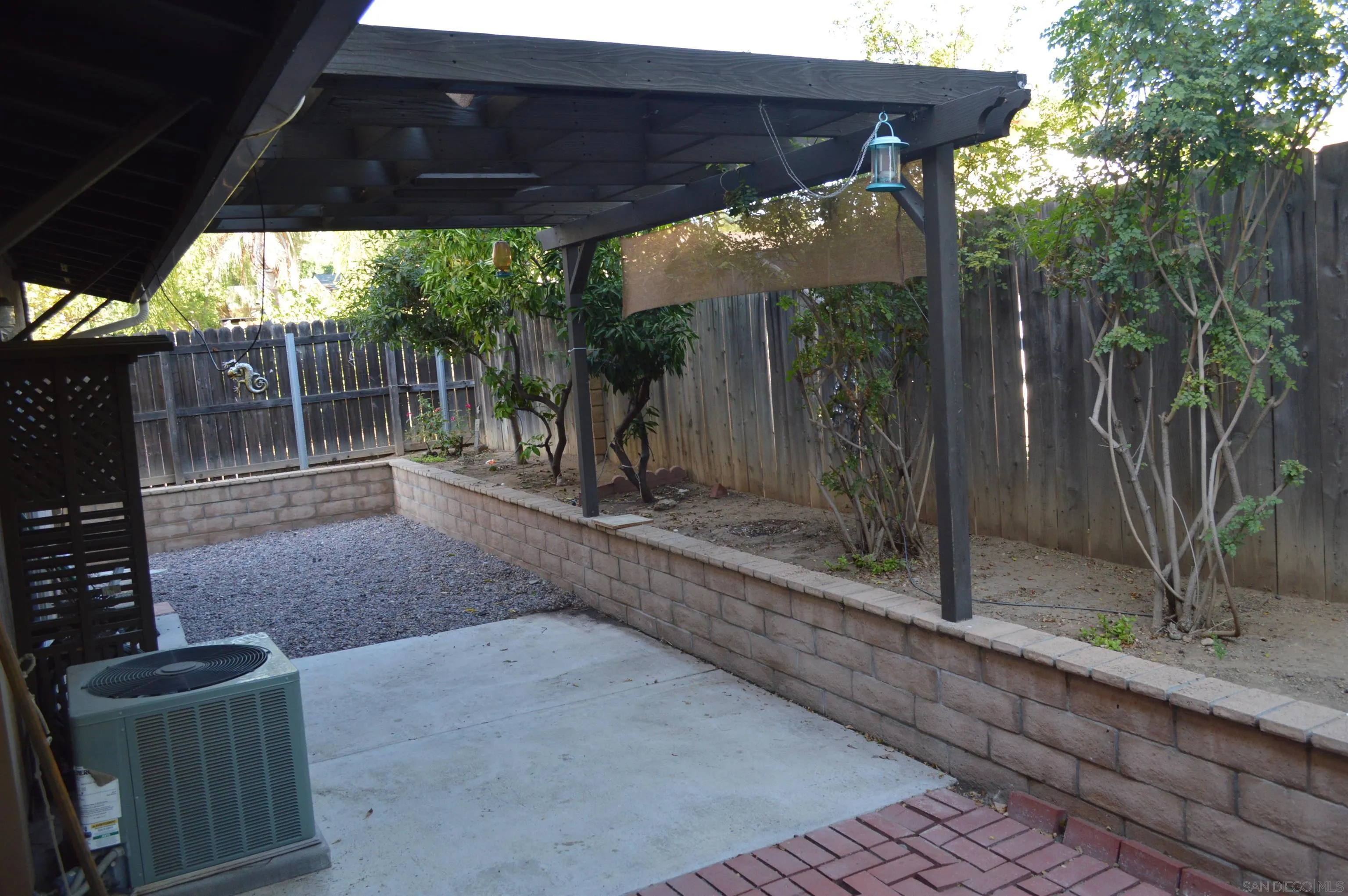 13353 Sutter Mill Road Poway, CA 92064 - Photo 4 of 14 a view of a backyard with floor to ceiling window and wooden fence