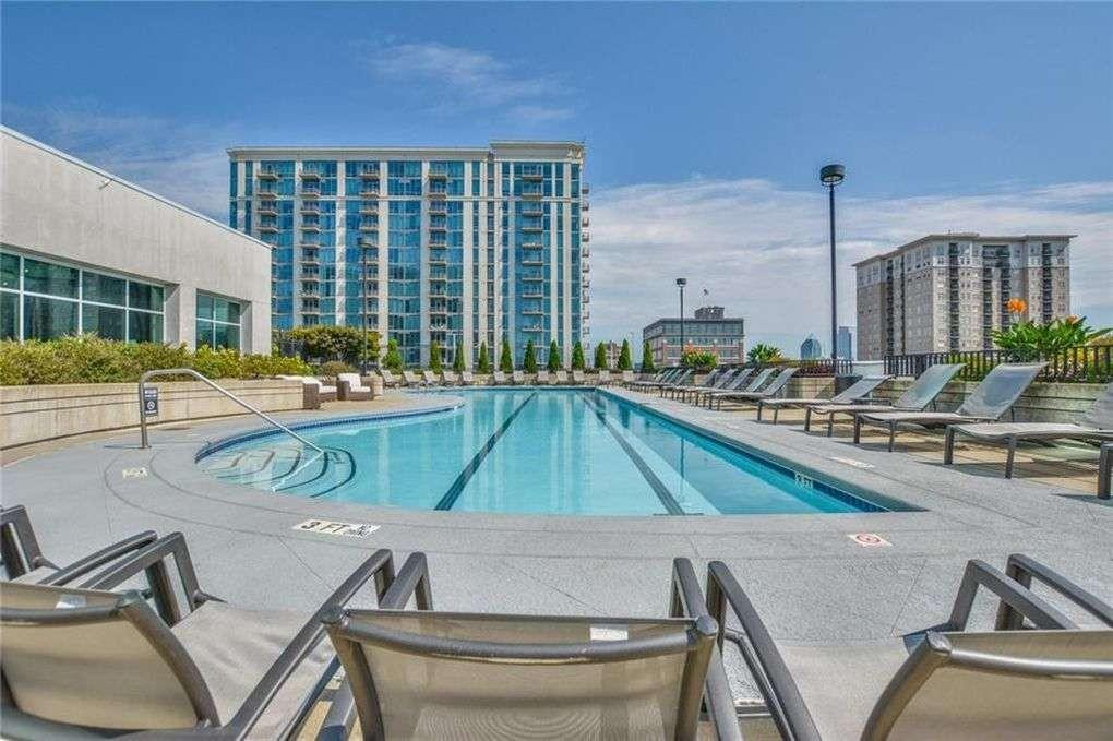 250 Pharr Road Northeast, Unit 2002 Atlanta, GA 30305 - Photo 9 of 13 a view of a swimming pool with outdoor seating