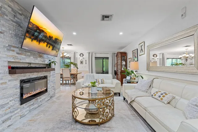 a living room with furniture a fireplace and a flat screen tv