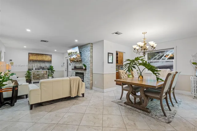 a view of a dining room with furniture and chandelier