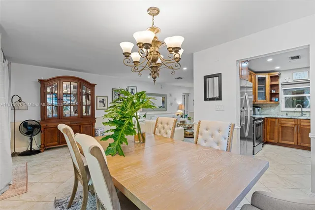a view of a dining room with furniture and chandelier