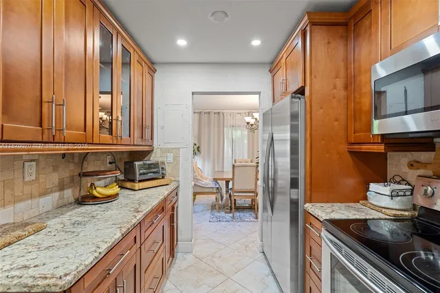 a kitchen with stainless steel appliances granite countertop a sink stove and cabinets