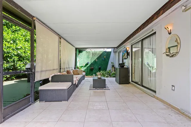 a living room with furniture and large windows