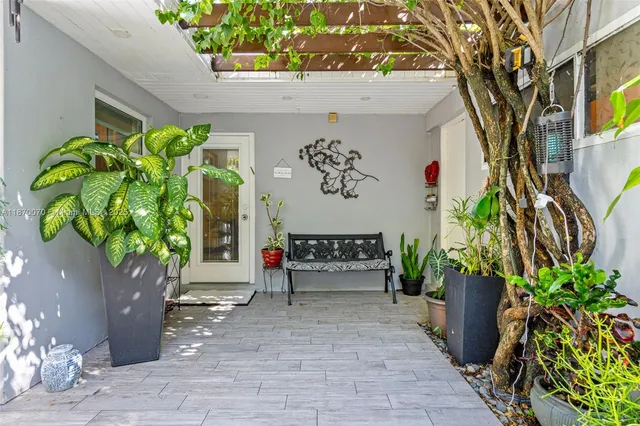 a view of a entryway door with flower in