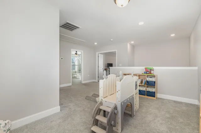 a dining room with a table and chairs
