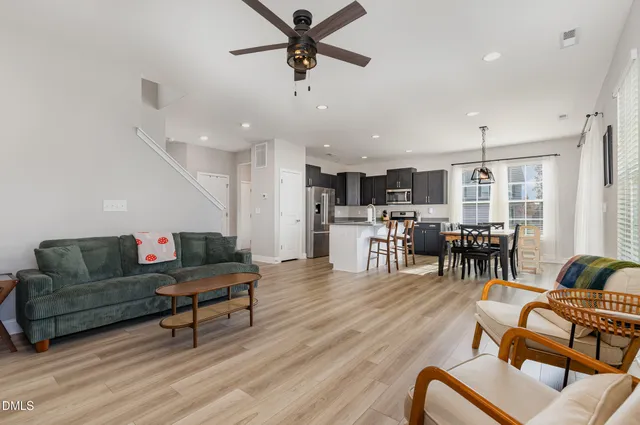 a living room with furniture and kitchen view