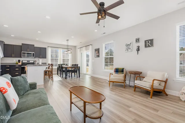 a living room with furniture and kitchen view