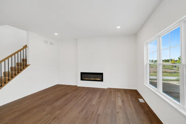 a view of a room with wooden floor and a window