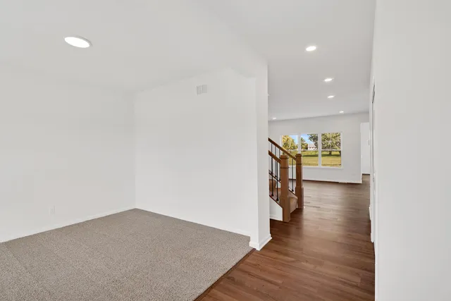 a view of an empty room and wooden floor
