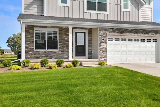 a view of a house with a yard and sitting area