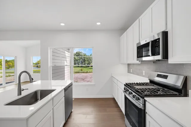 a kitchen with a sink and a stove top oven