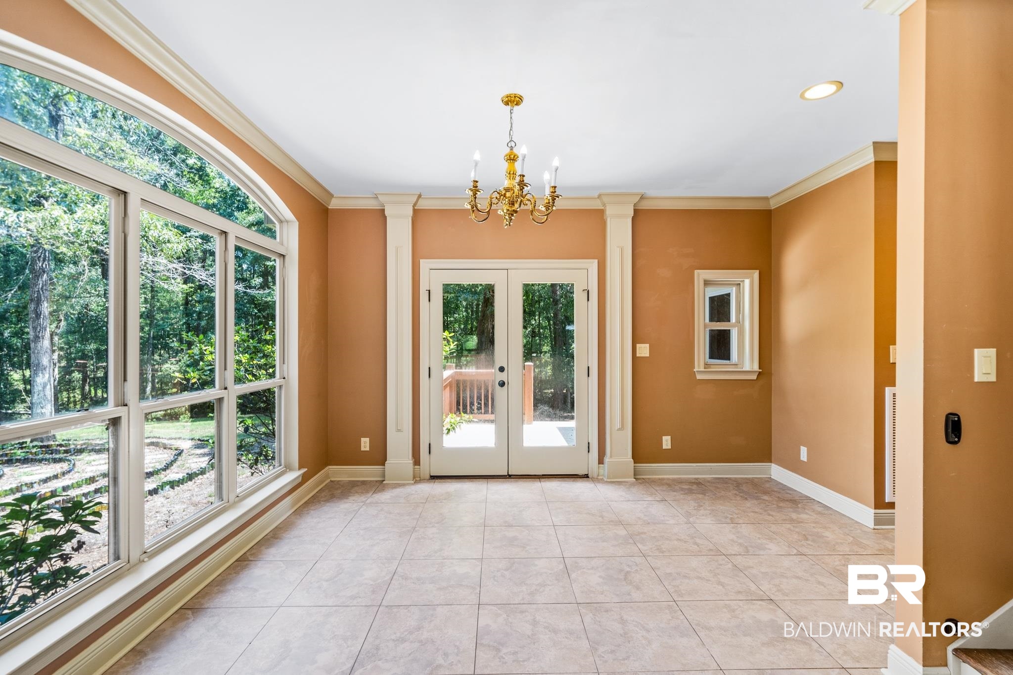 8321 Dixon Road Bay Minette, AL 36507 - Photo 34 of 79 Doorway to outside with an inviting chandelier, light tile patterned flooring, and a healthy amount of sunlight