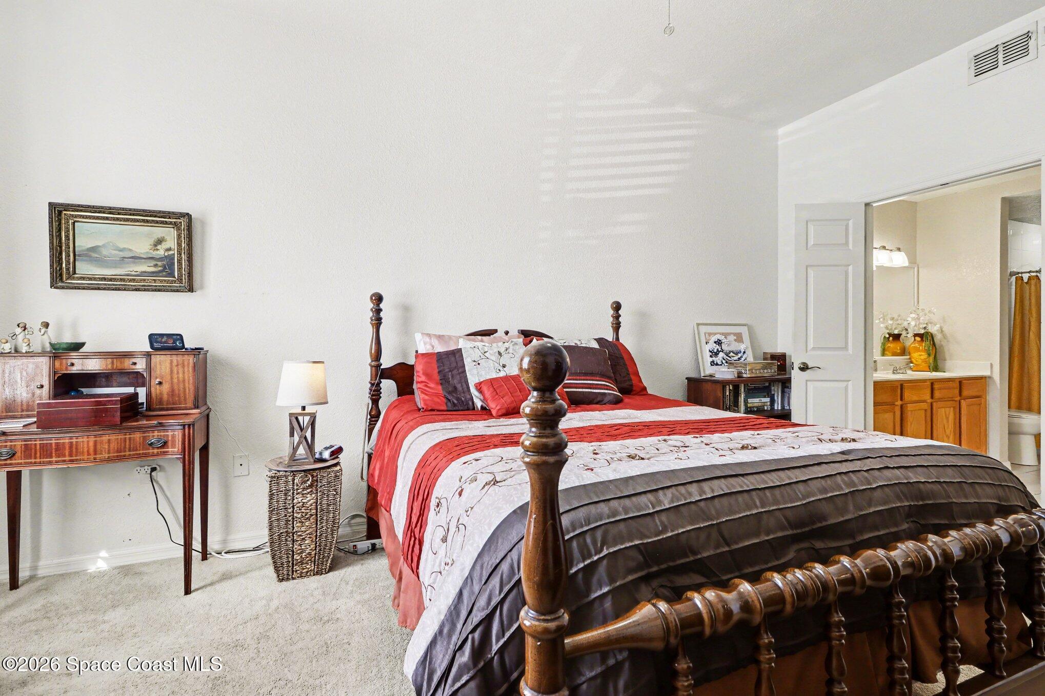 3955 Almeida Court, Unit 103 Melbourne, FL 32901 - Photo 14 of 32 a bed room with a bed and a desk