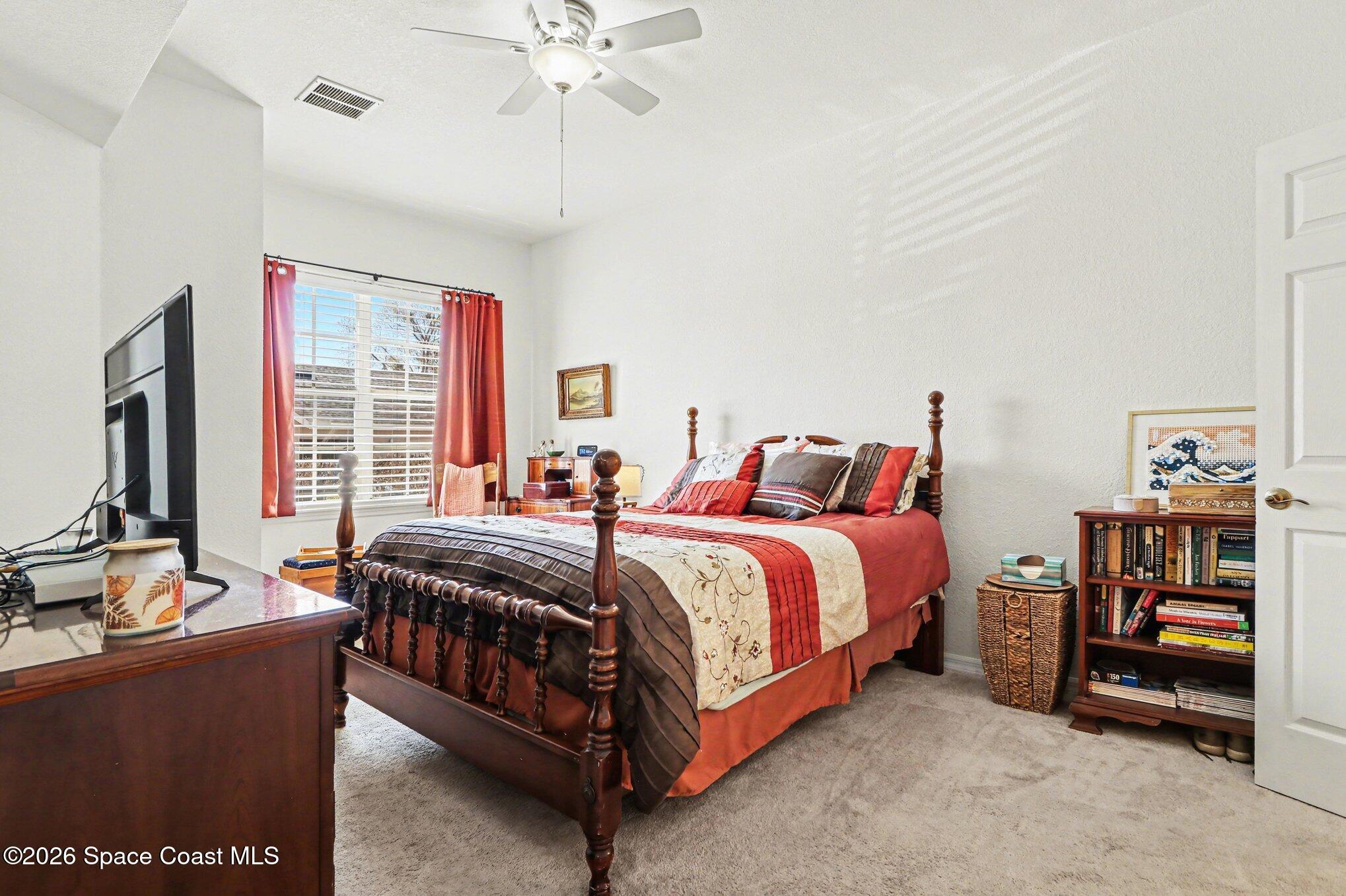 3955 Almeida Court, Unit 103 Melbourne, FL 32901 - Photo 15 of 32 a bed sitting in a bedroom next to a window