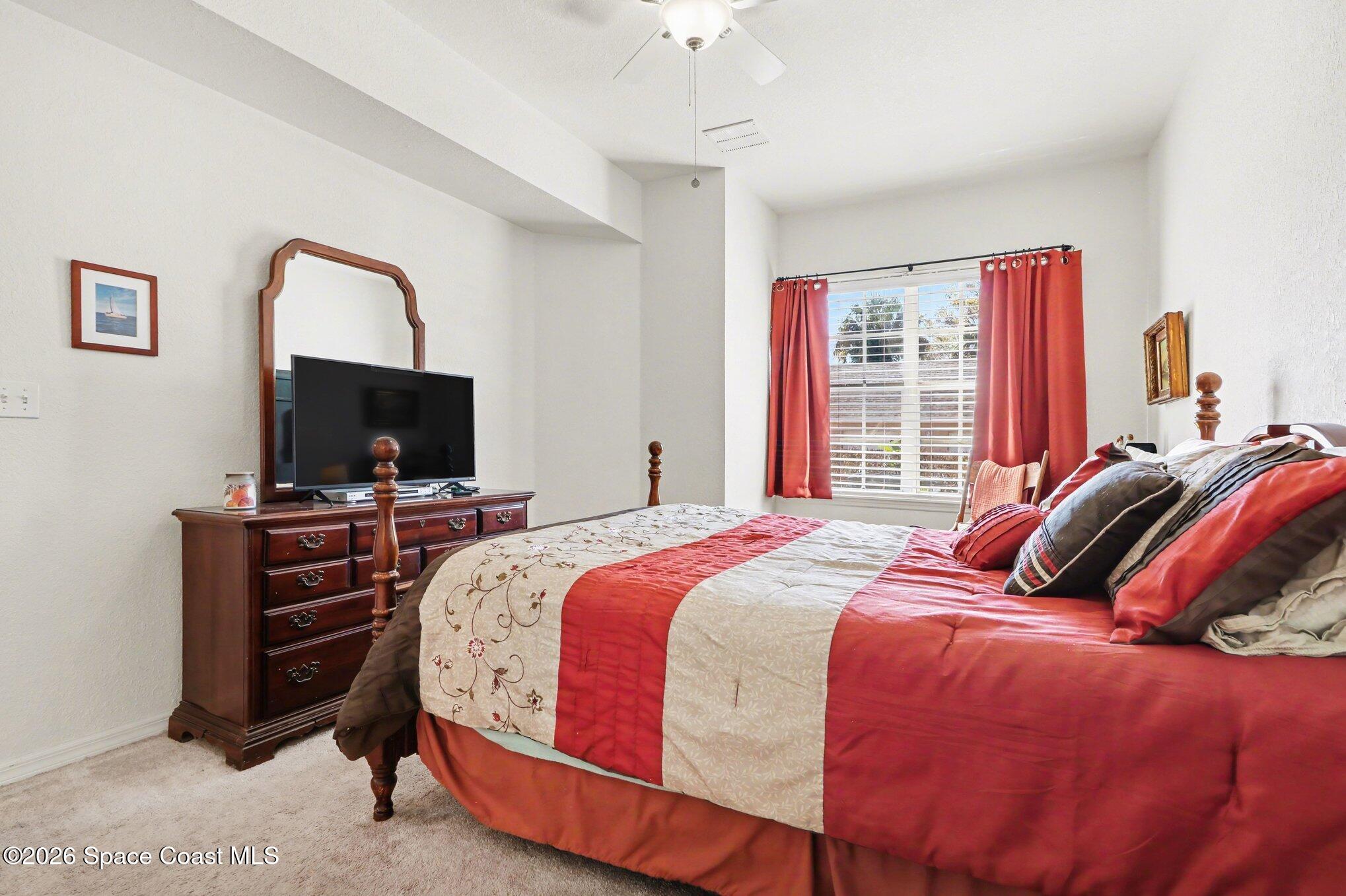 3955 Almeida Court, Unit 103 Melbourne, FL 32901 - Photo 16 of 32 a bedroom with a bed and a flat screen tv