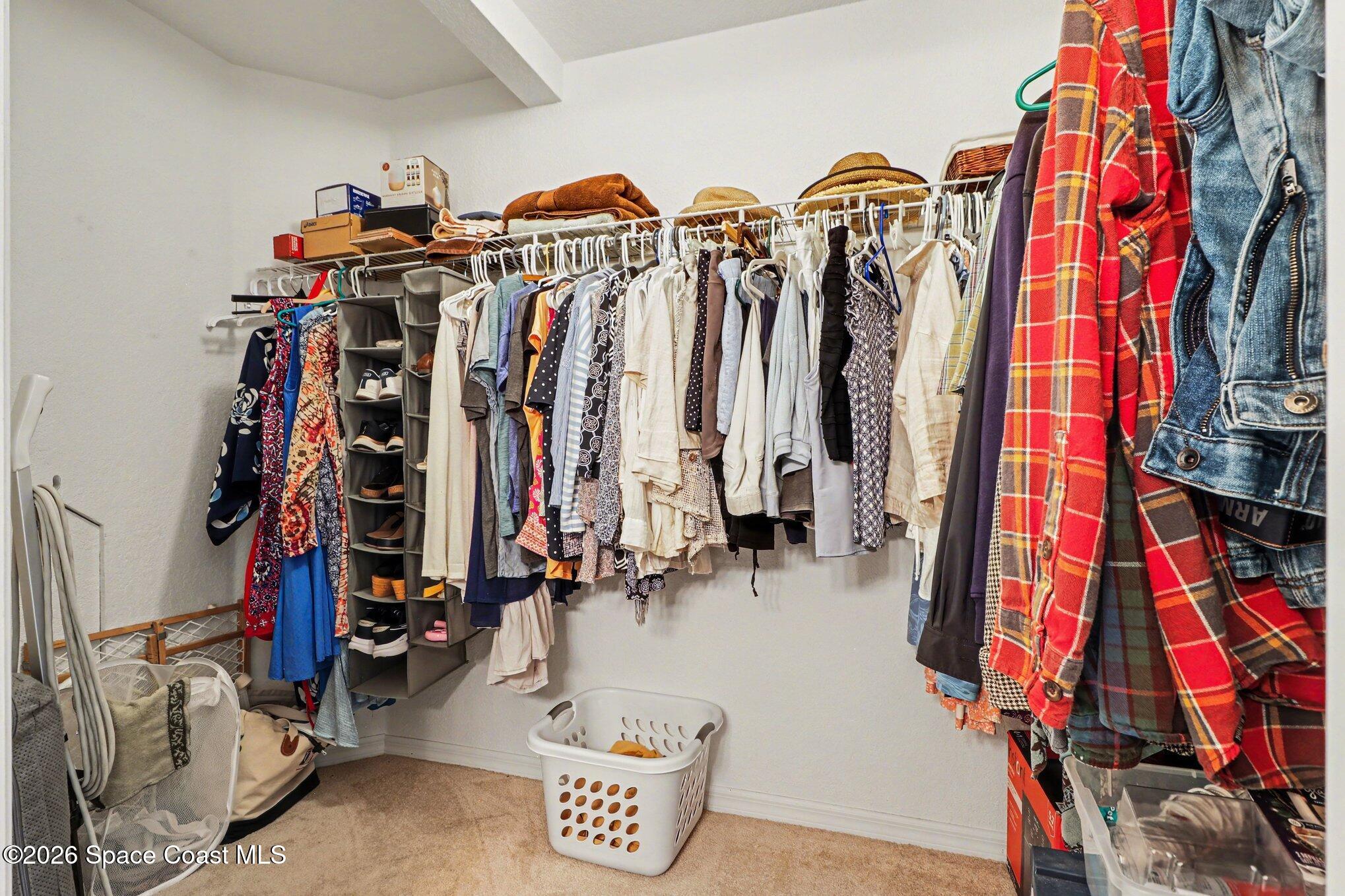 3955 Almeida Court, Unit 103 Melbourne, FL 32901 - Photo 19 of 32 a view of walk in closet with clothes