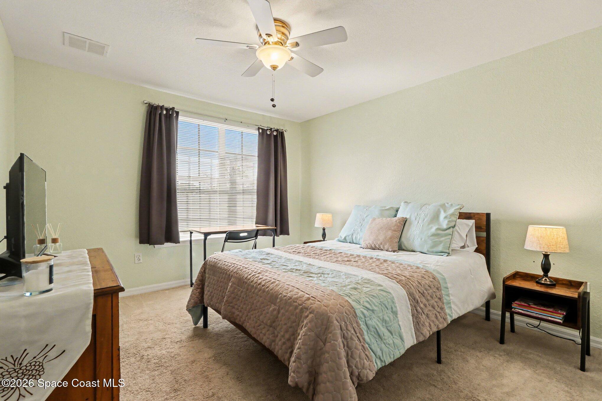 3955 Almeida Court, Unit 103 Melbourne, FL 32901 - Photo 20 of 32 a bedroom with a bed couch and window