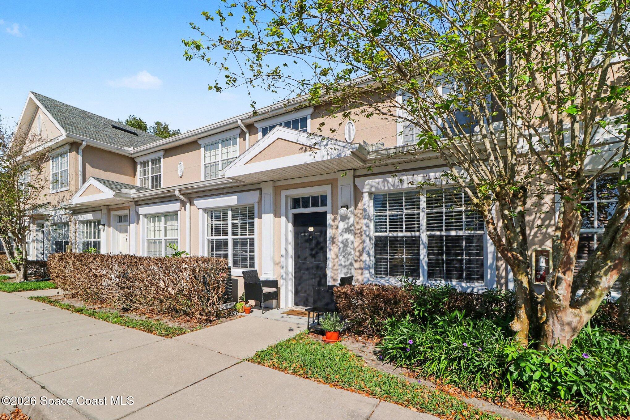 3955 Almeida Court, Unit 103 Melbourne, FL 32901 - Photo 2 of 32 front view of a house with a tree