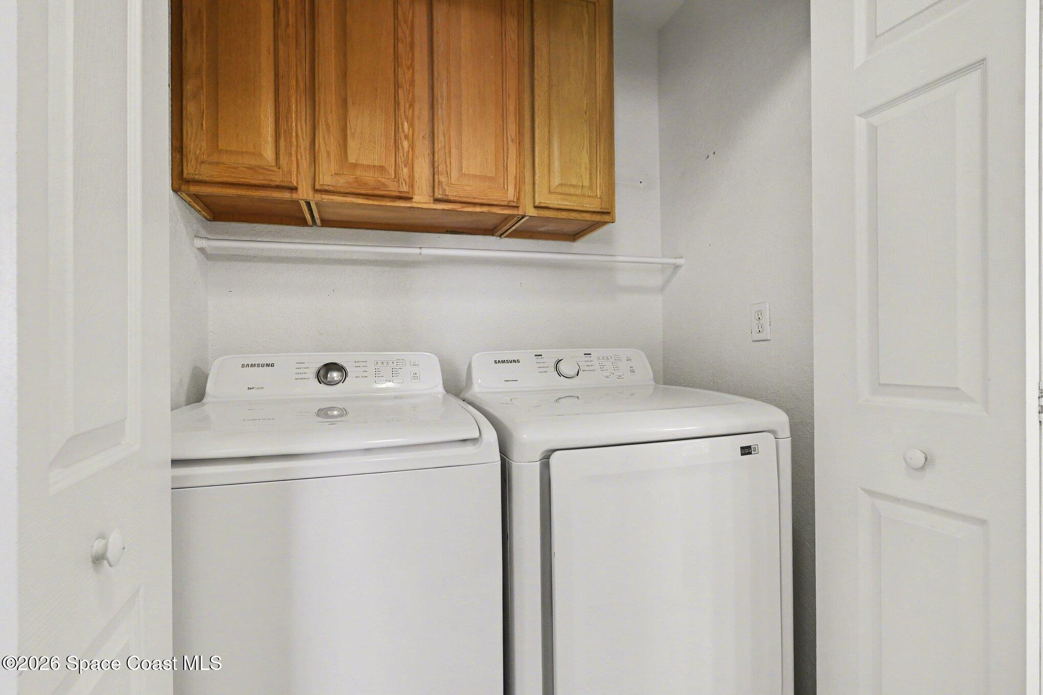 3955 Almeida Court, Unit 103 Melbourne, FL 32901 - Photo 25 of 32 a utility room with dryer and washer