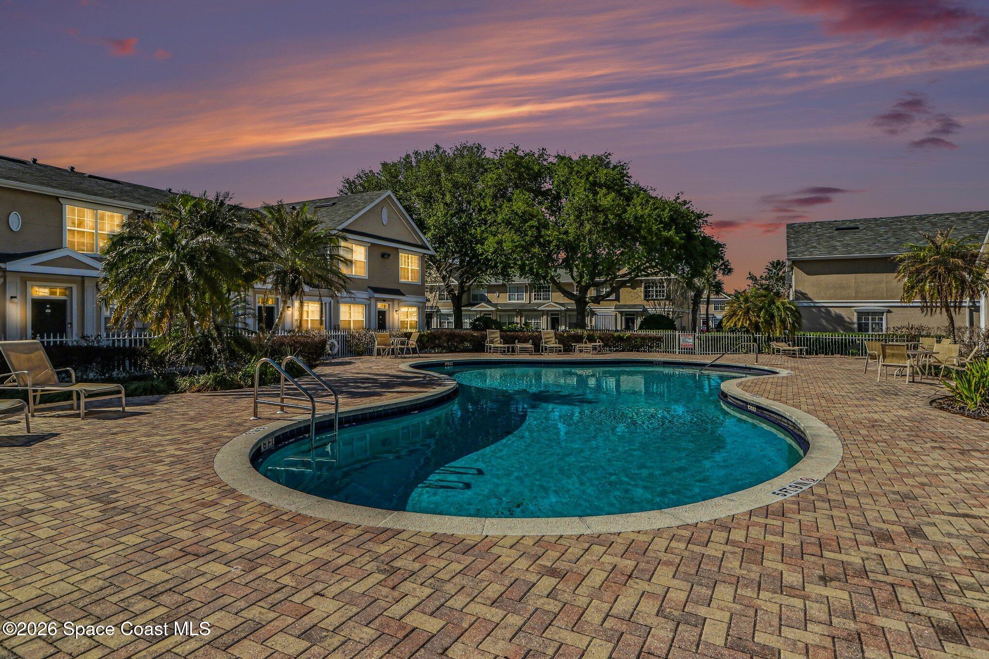 3955 Almeida Court, Unit 103 Melbourne, FL 32901 - Photo 27 of 32 a view of a swimming pool with a patio