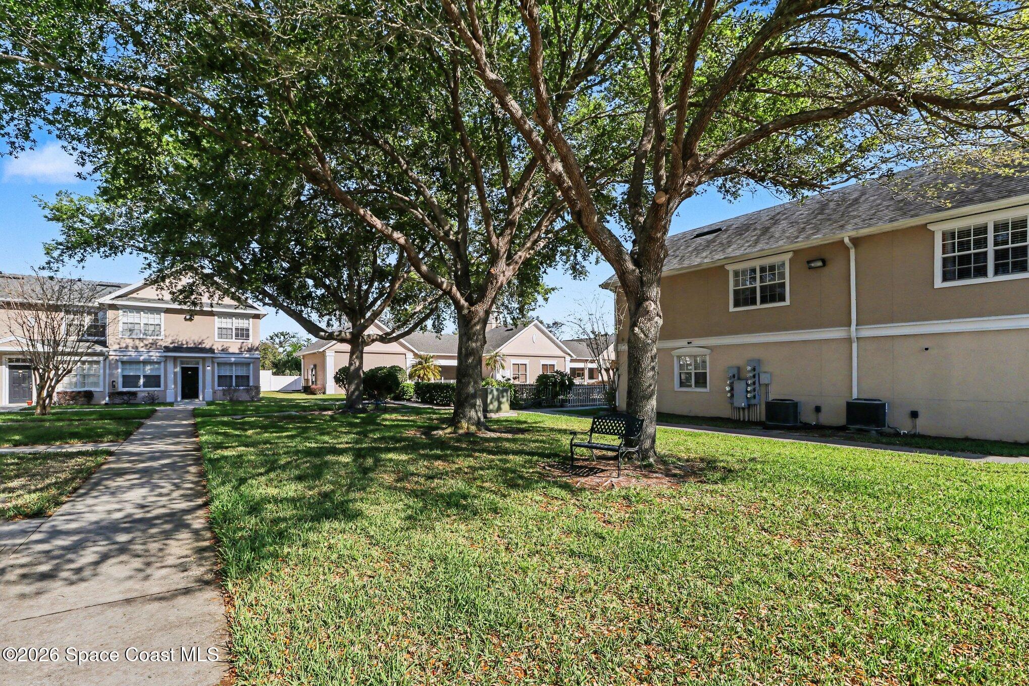 3955 Almeida Court, Unit 103 Melbourne, FL 32901 - Photo 28 of 32 a house that has a tree in front of it